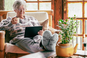 Life Assure Senior Woman Sitting In Chair And Laughing With Caregiver Nurse Blog